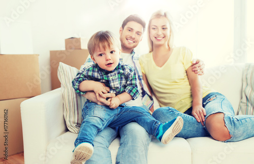 happy family with boxes moving to new home