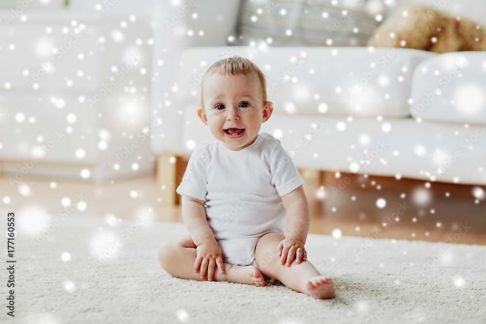 happy baby boy or girl sitting on floor at home happy baby boy or girl sitting on floor at home