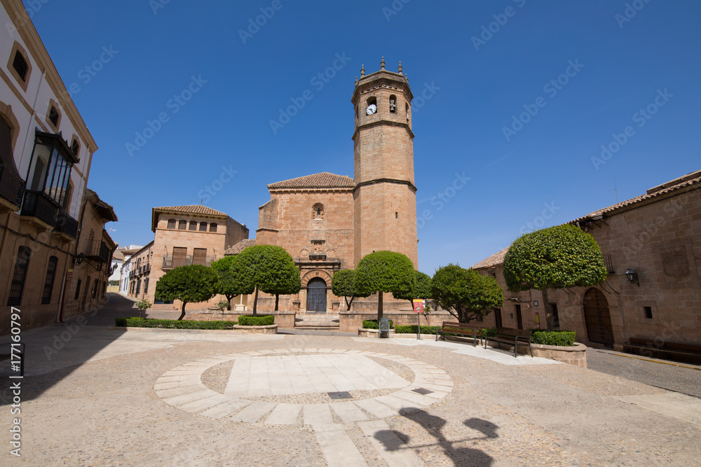 landmark Constitution Square, with facade and bell tower of church San Mateo, gothic and renaissance from Fifteenth century, in old town of Banos de la Encina, Jaen, Andalusia, Spain Europe
