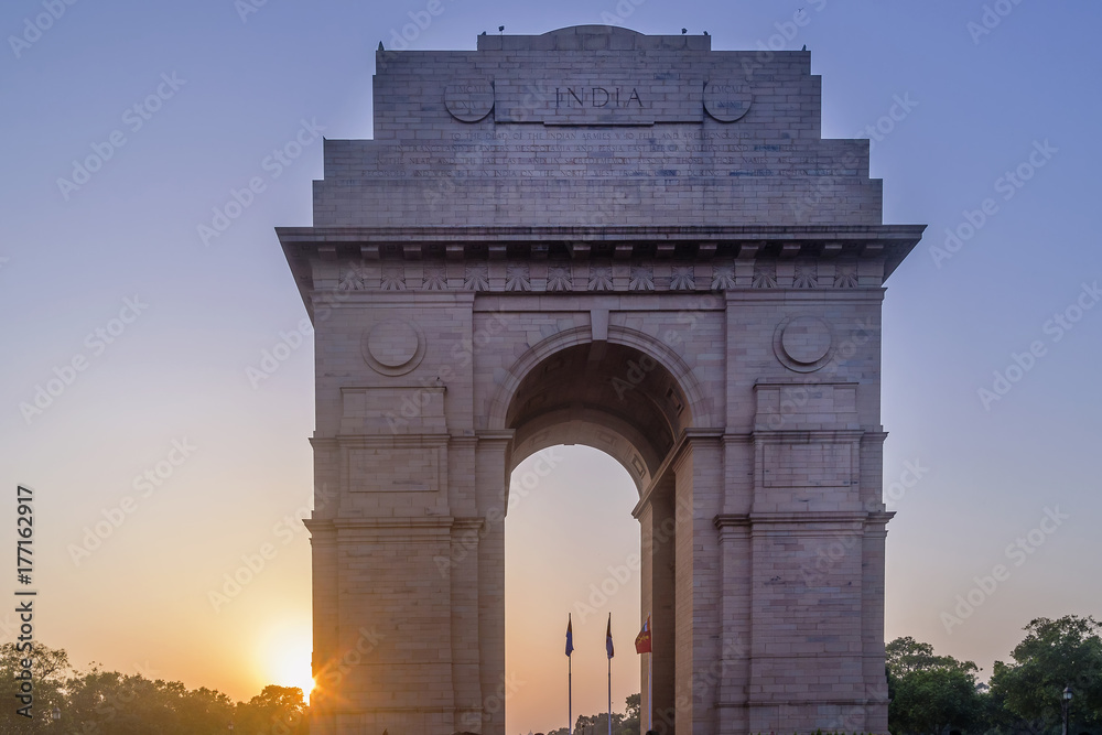 The sun sets behind the famous India Gate, New Delhi, India