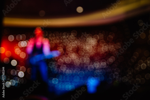 Blurred guitar player on a club stage photo