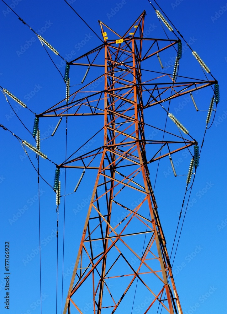 Rusty Transmission Tower (Electricity Pylon) with vibrant blue sky. Rusty Transmission Tower (Electricity Pylon) with vibrant blue sky.