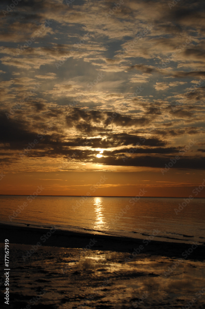 Fototapeta premium Beautiful deep red sunset on the coast of the Gulf of Riga, j?rmala, Latvia