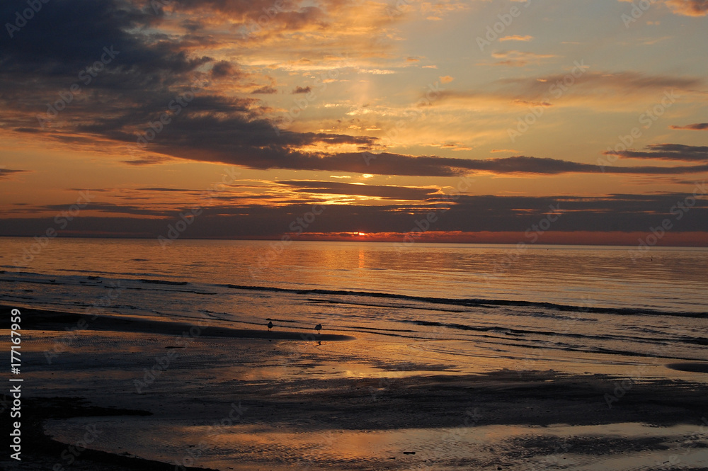 Fototapeta premium Beautiful deep red sunset on the coast of the Gulf of Riga, j?rmala, Latvia