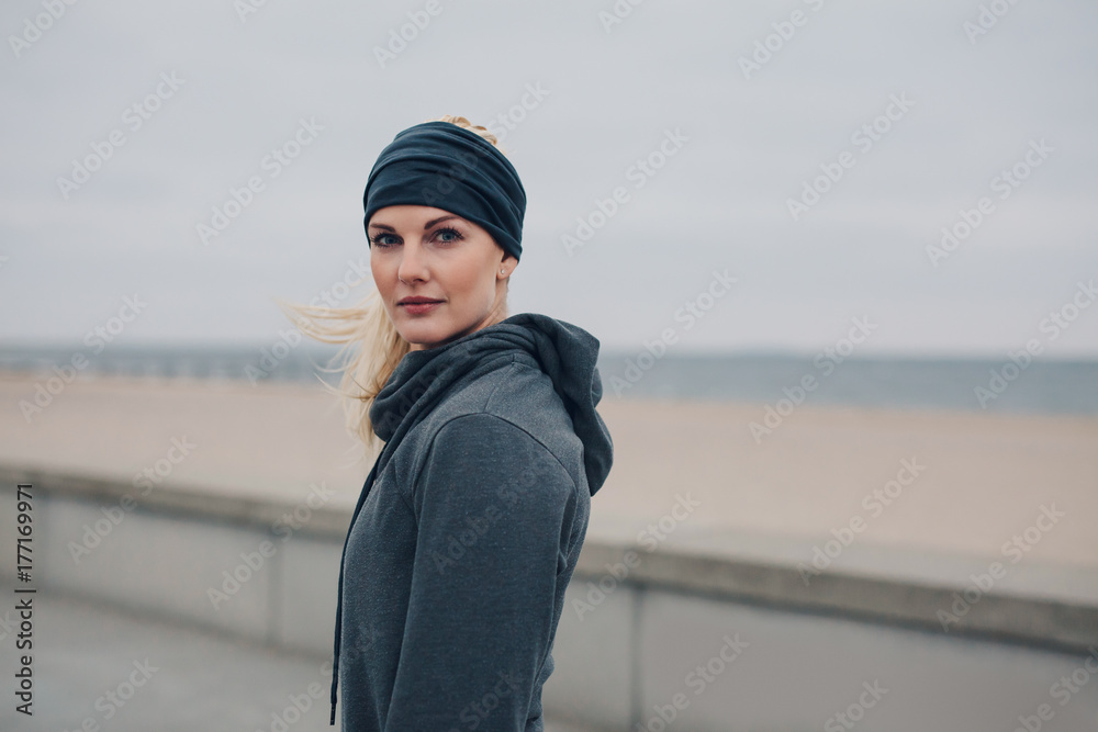 Young female jogger standing outdoors after a run Young female jogger standing outdoors after a run