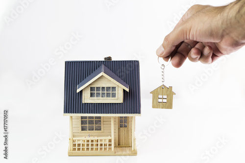 Buying new real estate concept, house and key on hand. Protect Your Home Concept 