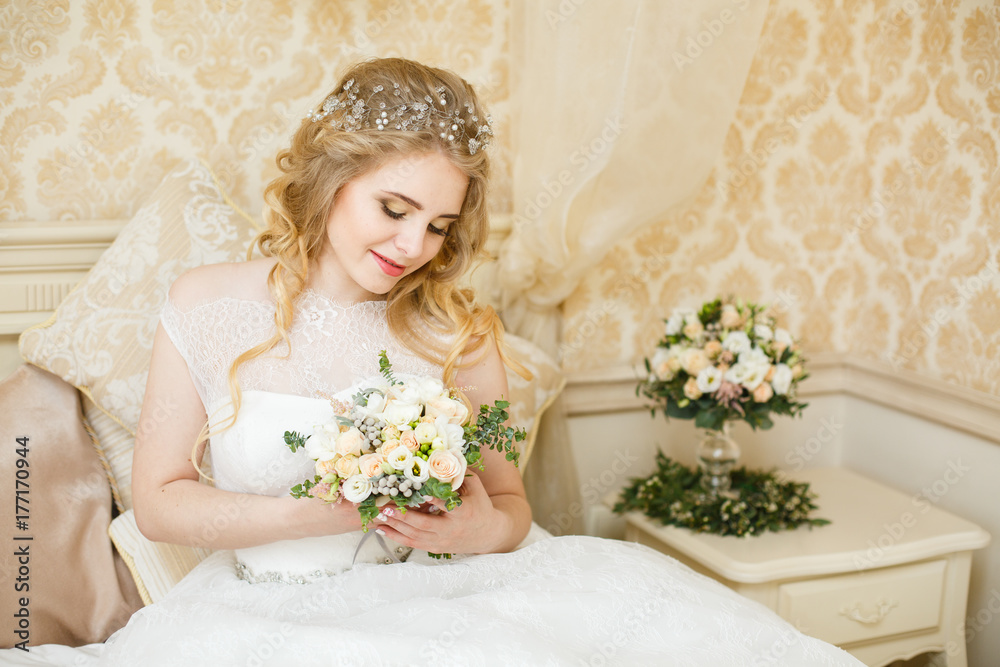 Beautiful young Bride with blonde hairs in a bedroom. Classic white wedding dress. Half-length portrait Beautiful young Bride with blonde hairs in a bedroom. Classic white wedding dress. Half-length portrait