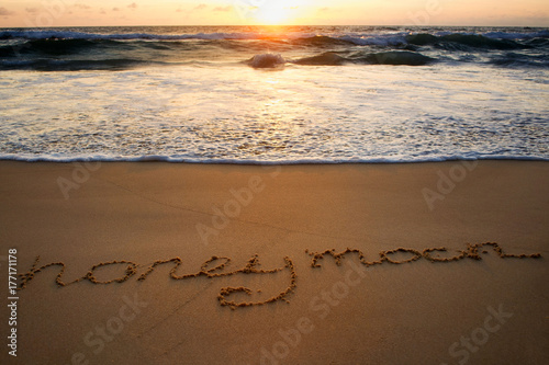 Honeymoon is written on the sand 