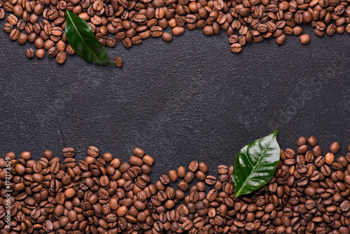 Coffe beans with coffe leaves on black background photo