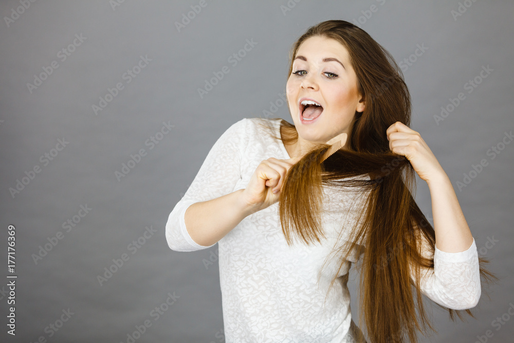 Happy woman brushing her hair