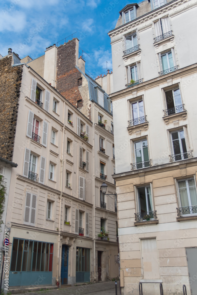 Paris, beautiful facades in Montmartre, charming typical building 
