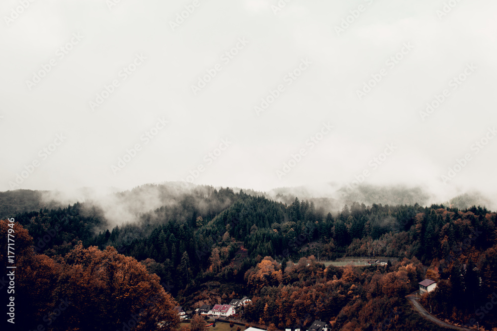 clouds and fog over the village in the mountains. autumn. Germany
