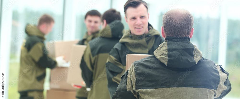Fototapeta premium workers unload boxes