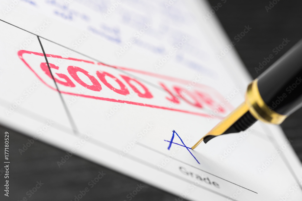 Close up of stamp good job and grade a on a document. Close up of stamp good job and grade a on a document.