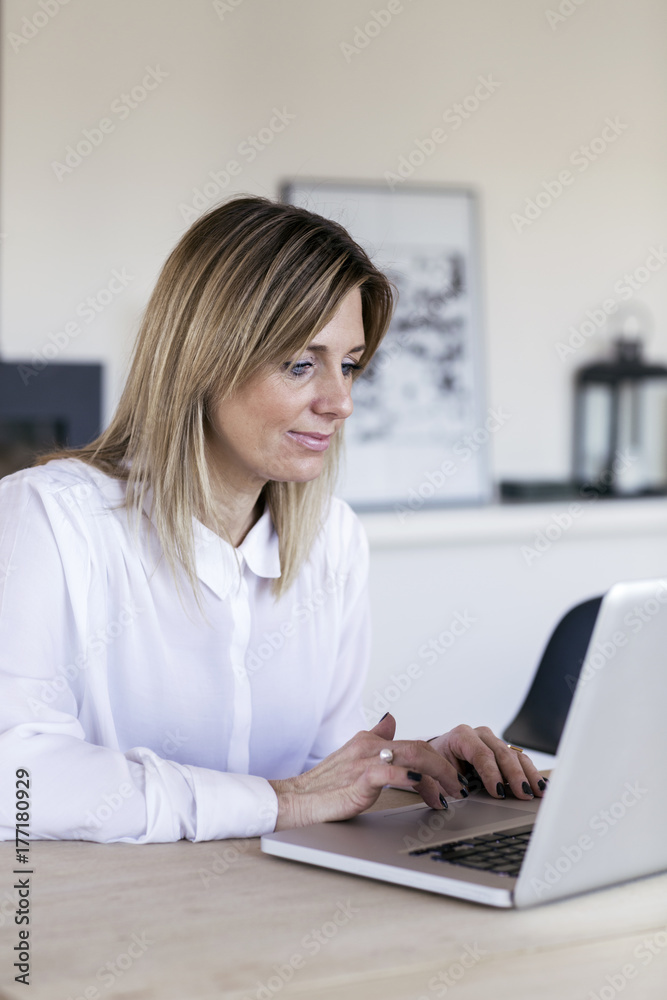 Businesswoman in white shirt typing on computer Businesswoman in white shirt typing on computer