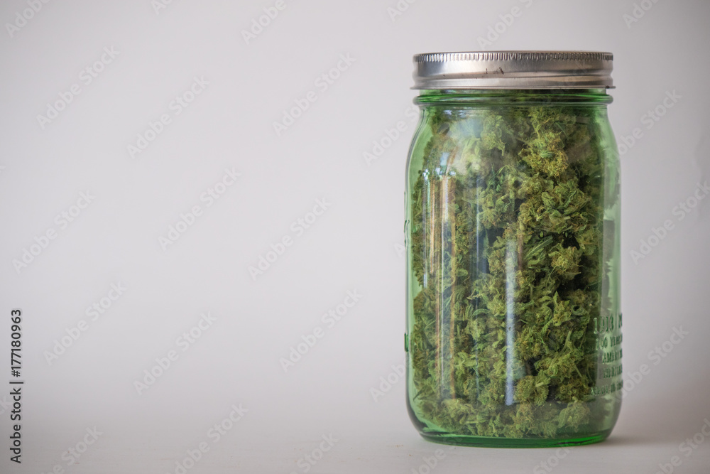 White background jar of medical marijuana White background jar of medical marijuana