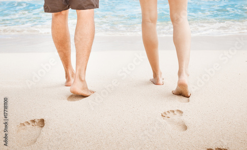 Couple walking on sand beach