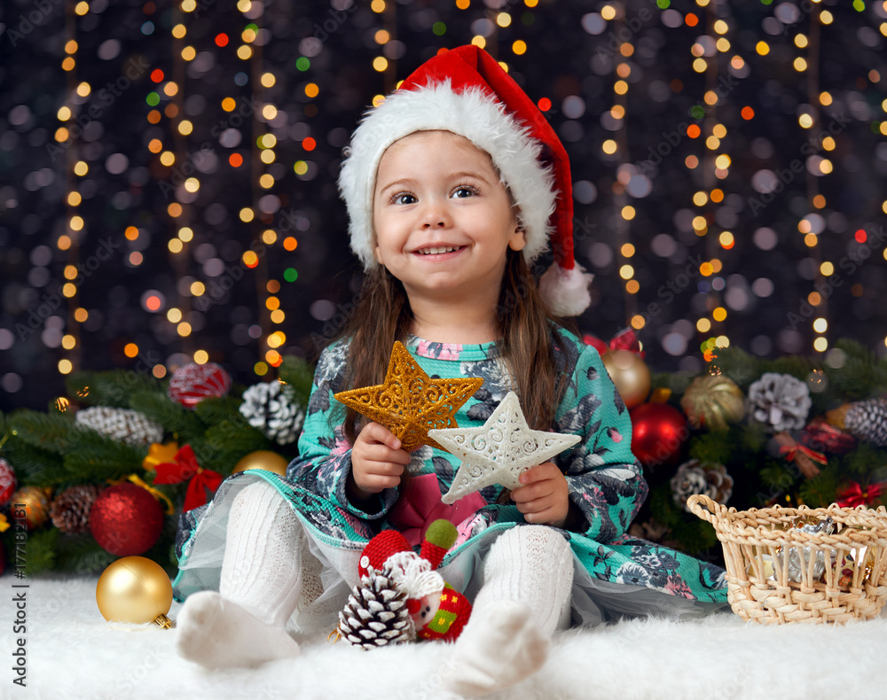 girl portrait in christmas decoration with gift, dark background with illumination and boke lights, winter holiday concept