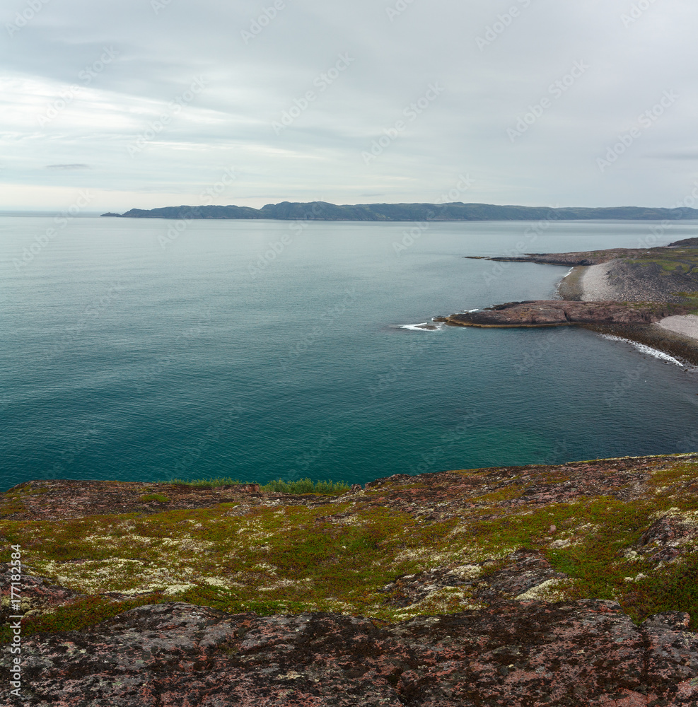 View on the rocky shore of the Barents sea. Kola Peninsula, The Arctic, Russia. View on the rocky shore of the Barents sea. Kola Peninsula, The Arctic, Russia.