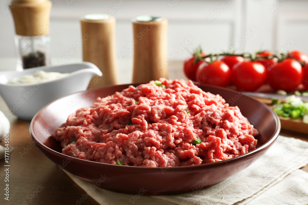 Plate with fresh raw minced meat on table Plate with fresh raw minced meat on table