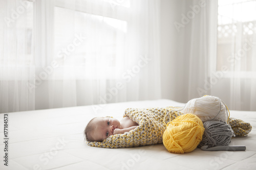 Baby in crochet blanket photo