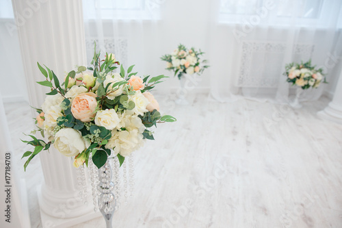 Artificial flowers. Vase with a flower arrangement in an expensive interior.