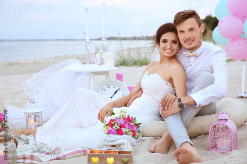 Happy wedding couple on beach