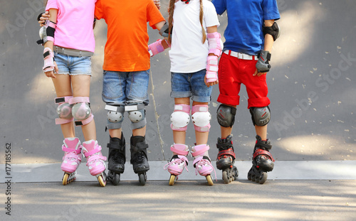 Cute children on rollers in...