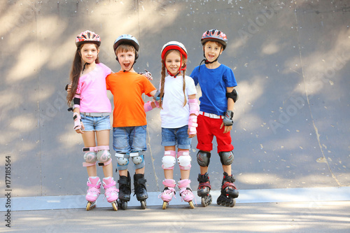 Cute children on rollers in...