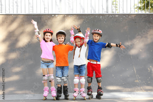 Cute children on rollers in...