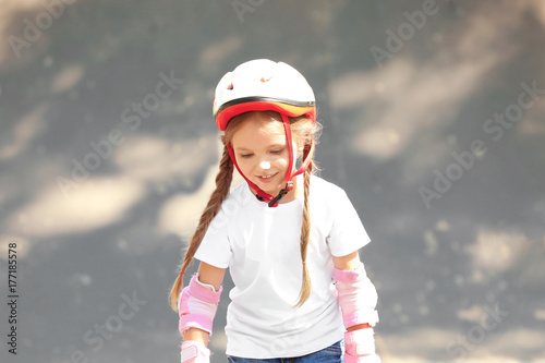 Cute girl rollerblading in ...