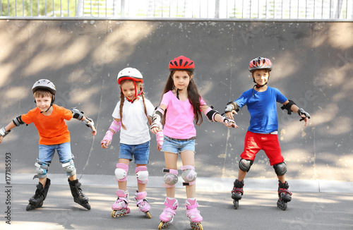 Active children rollerblading in skate park