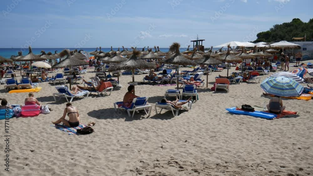 Cala Ratjada Mallorca Spain: Tourists sunbathing on the Son Moll beach Cala Ratjada Mallorca Spain: Tourists sunbathing on the Son Moll beach