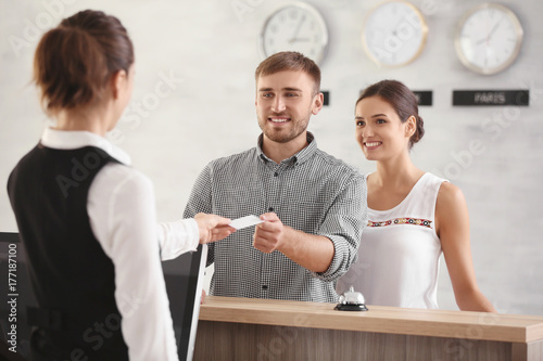 Young couple receiving key ...