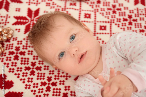 Adorable baby lying on bed ...