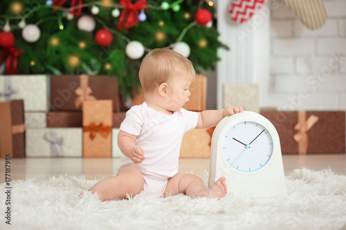 Adorable baby with clock in...