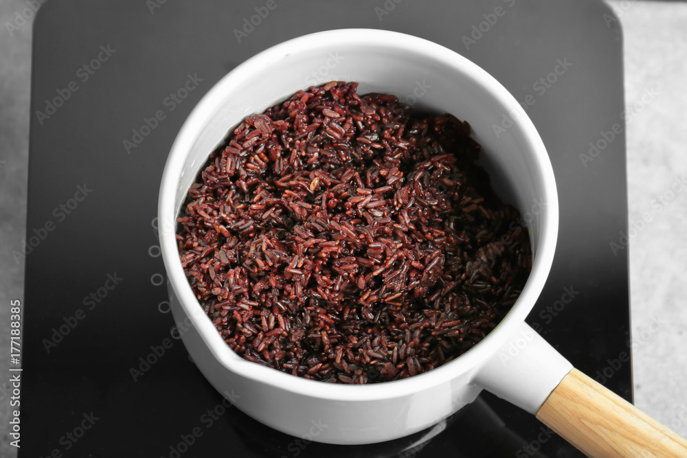 Saucepan with boiled rice in kitchen Saucepan with boiled rice in kitchen
