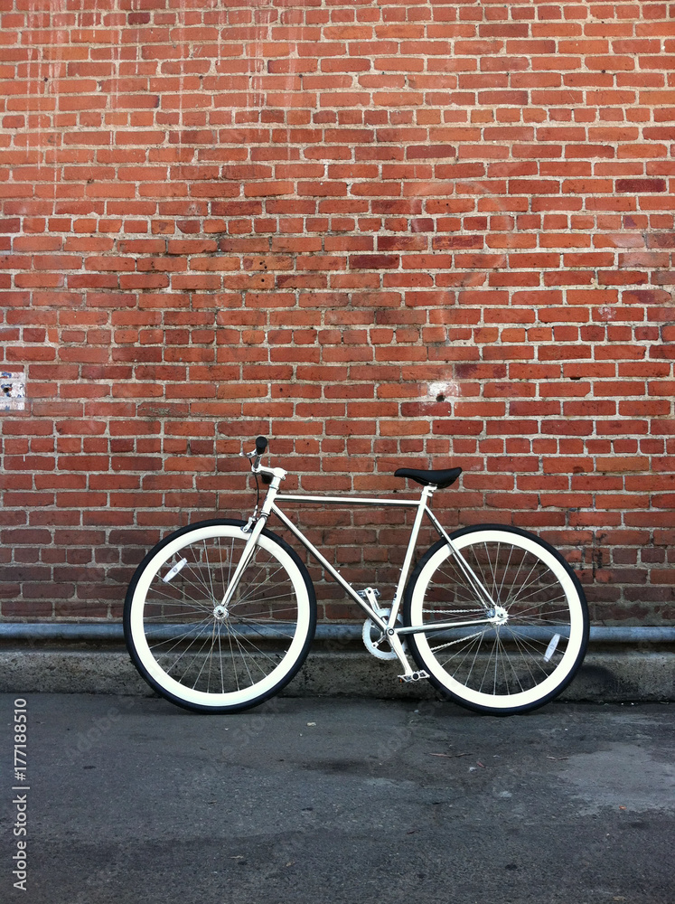 Fixed gear bicycle against red brick wall Fixed gear bicycle against red brick wall