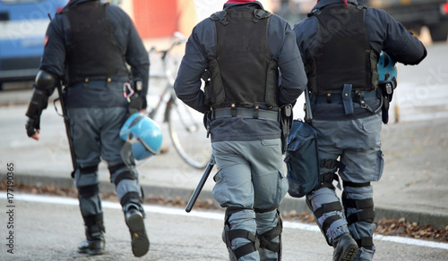 policemen with anti-bulletproof jacket patrol the streets of the