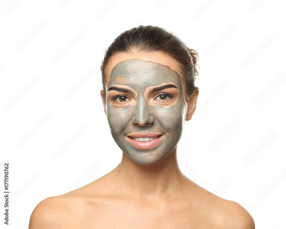 Young woman with facial mask on white background