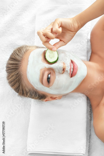 Young woman with facial mas...