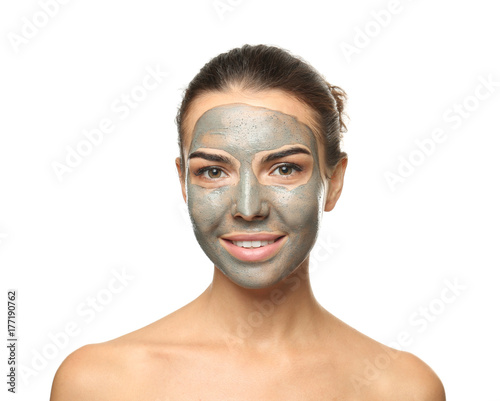 Young woman with facial mask on white background