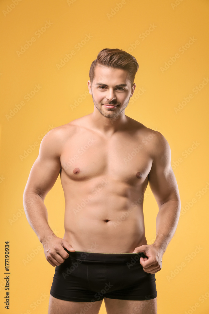 Fototapeta premium Sexy shirtless man in underwear on color background