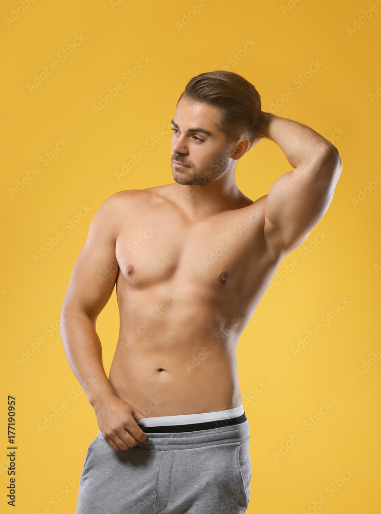 Fototapeta premium Sexy shirtless man on color background