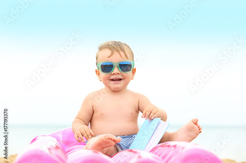Cute baby boy sitting on in...
