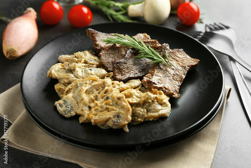 Plate with steak Diane on table