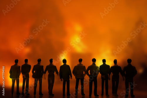 Silhouettes of people watching fire in the forest, conceptual image