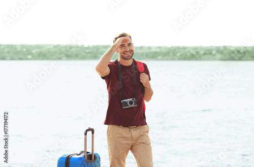 Handsome young tourist with...