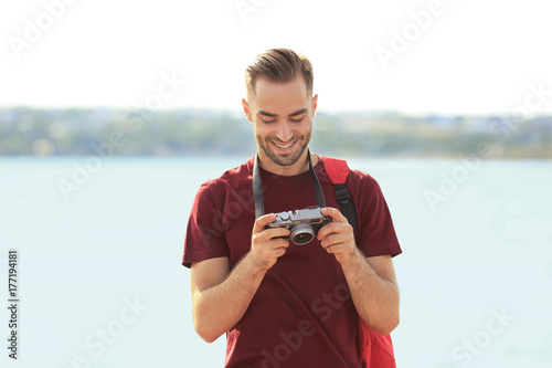 Handsome young tourist with...