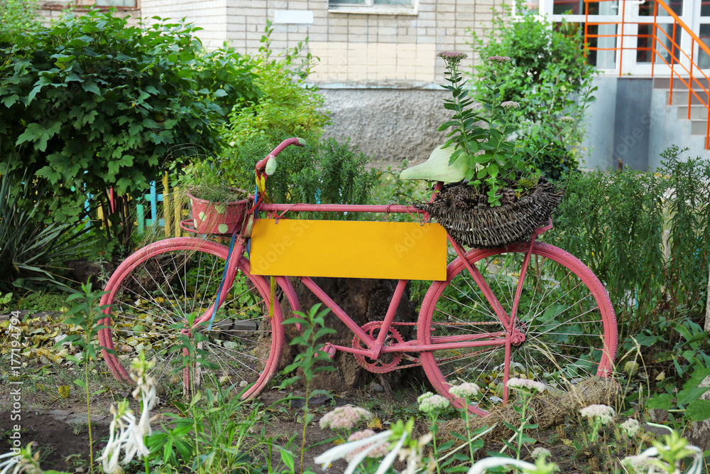 Old bicycle used as garden decor outdoors